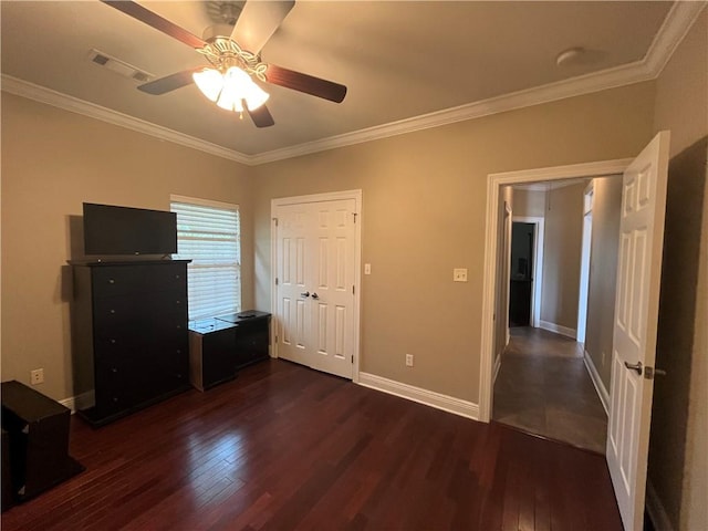 unfurnished bedroom with ceiling fan, crown molding, and dark wood-type flooring