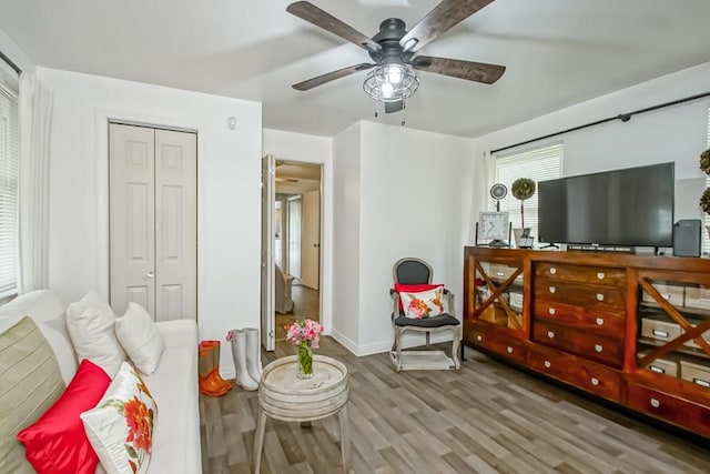 bedroom featuring ceiling fan, a closet, and light hardwood / wood-style floors