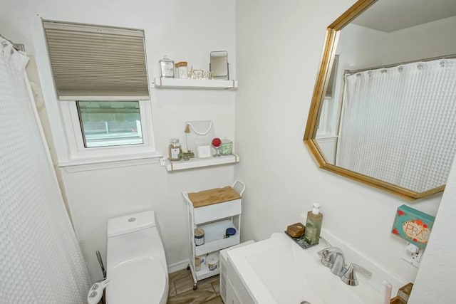 bathroom featuring toilet and sink