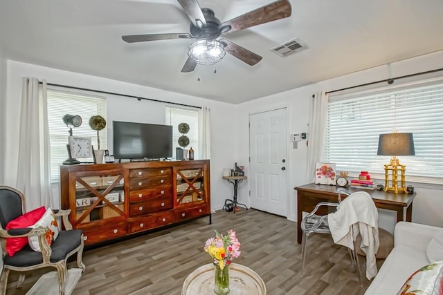 living room with hardwood / wood-style floors and ceiling fan