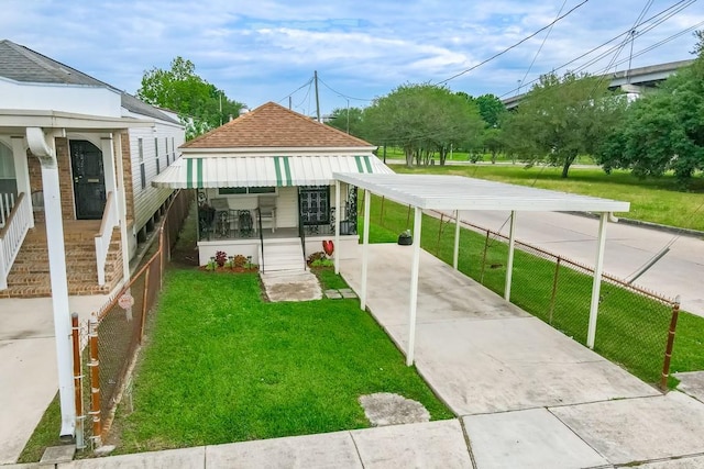 exterior space featuring a lawn and a carport