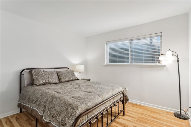 bedroom with hardwood / wood-style floors