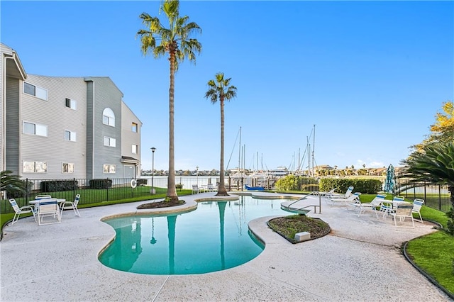 view of pool featuring a lawn and a patio