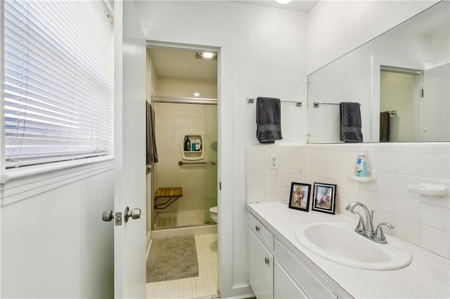 bathroom with tile patterned flooring, vanity, toilet, and a shower with door