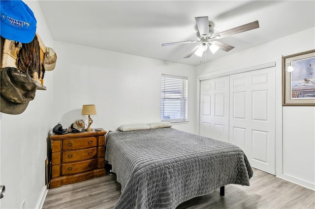 bedroom with ceiling fan, light wood-type flooring, and a closet