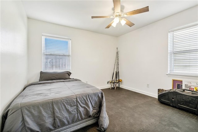 carpeted bedroom with multiple windows and ceiling fan