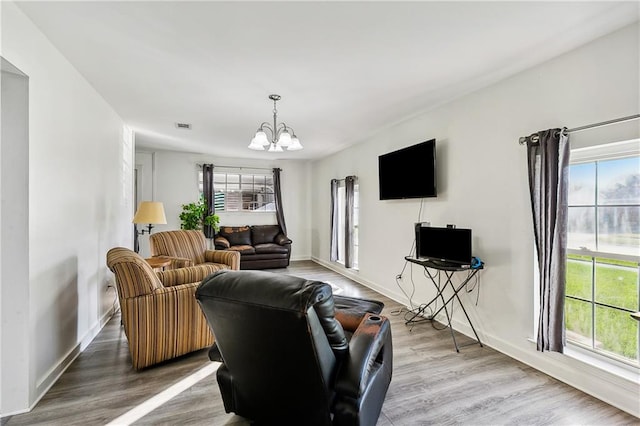 living room with wood-type flooring and a notable chandelier