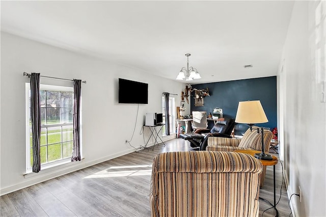 living room featuring hardwood / wood-style floors and a chandelier