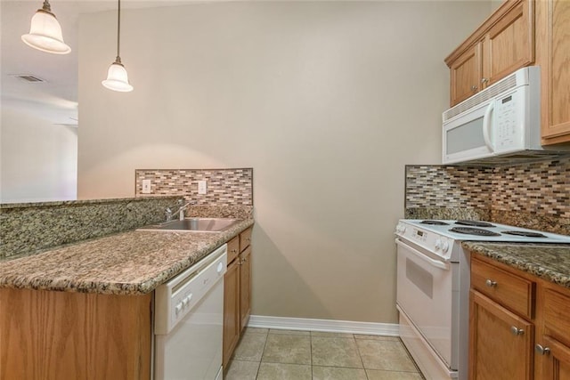 kitchen featuring white appliances, sink, hanging light fixtures, and tasteful backsplash