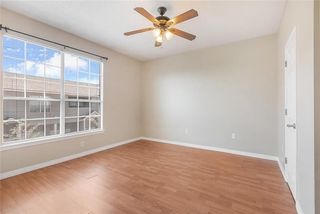 empty room featuring light wood-type flooring and ceiling fan