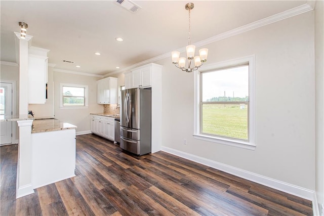 kitchen featuring white cabinets, hanging light fixtures, dark hardwood / wood-style floors, ornamental molding, and stainless steel appliances