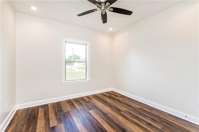 spare room with ceiling fan and dark hardwood / wood-style flooring