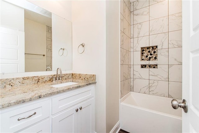 bathroom featuring vanity and tiled shower / bath combo