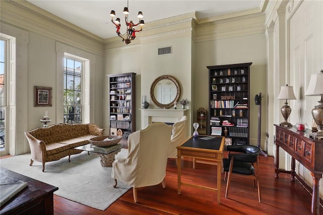 sitting room featuring hardwood / wood-style flooring, a notable chandelier, and crown molding