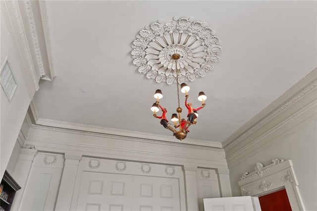 room details with a chandelier and ornamental molding