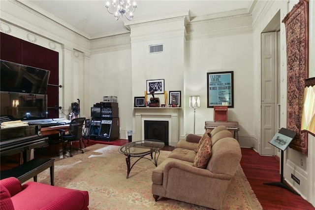 living room featuring a notable chandelier, dark wood-type flooring, a high ceiling, and ornamental molding