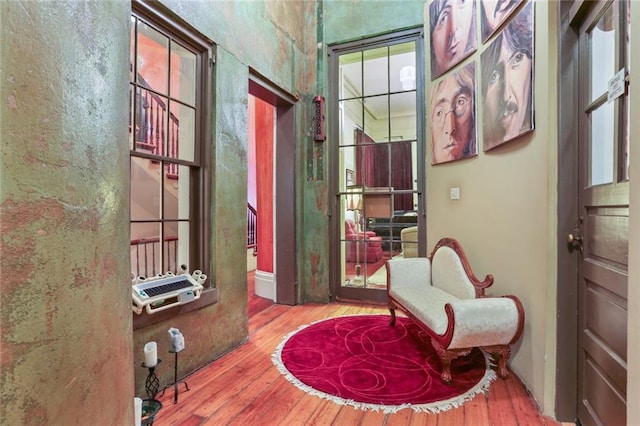 sitting room with wood-type flooring