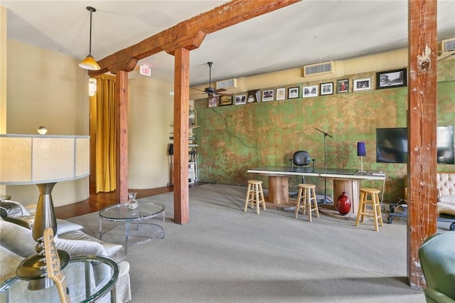 basement featuring carpet flooring and ceiling fan