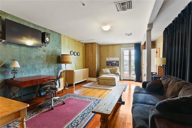 living room with hardwood / wood-style floors and french doors