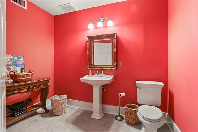 bathroom featuring sink, tile patterned flooring, and toilet