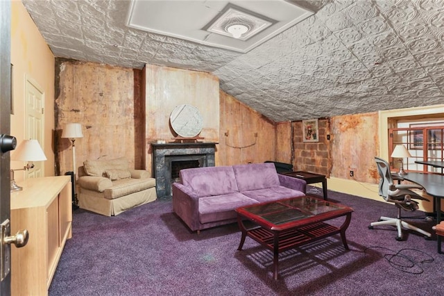 carpeted living room with wood walls and vaulted ceiling