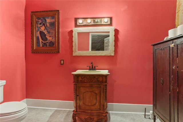 bathroom with tile patterned floors, vanity, and toilet