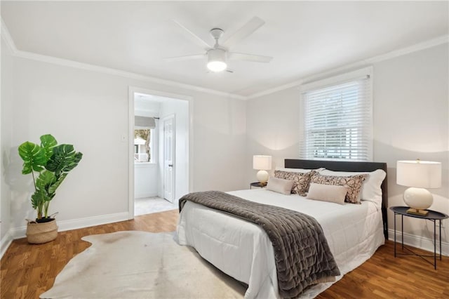 bedroom with wood-type flooring, multiple windows, ornamental molding, and ceiling fan