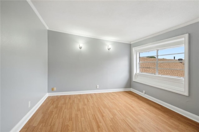 empty room featuring ornamental molding and light hardwood / wood-style flooring