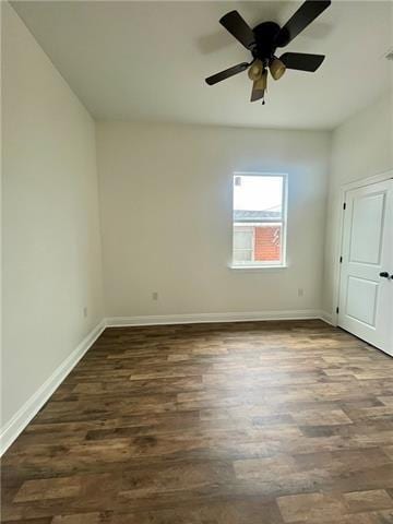 unfurnished room featuring ceiling fan and dark wood-type flooring