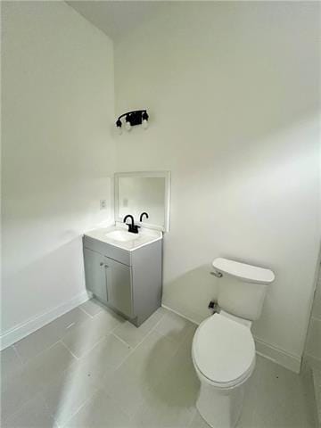 bathroom featuring tile patterned floors, vanity, and toilet