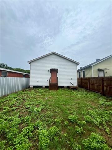 rear view of house with a yard