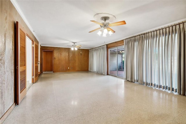 empty room with crown molding and wooden walls