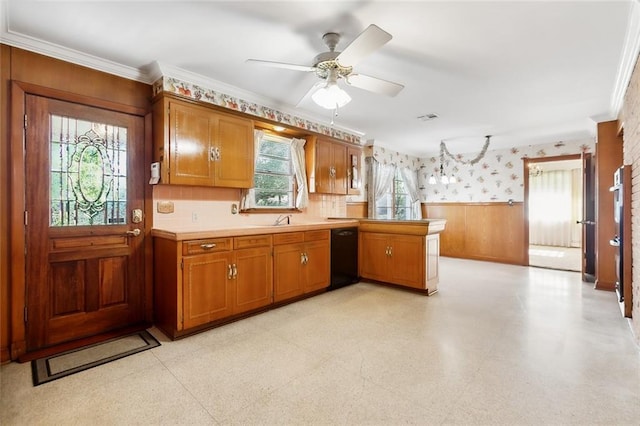 kitchen with kitchen peninsula, crown molding, a healthy amount of sunlight, and black dishwasher