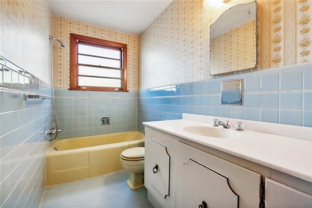 full bathroom with shower / bathing tub combination, vanity, toilet, and tile walls