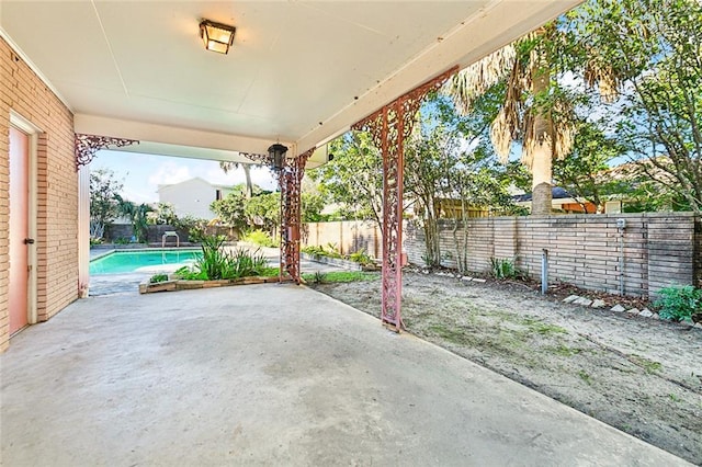 view of patio / terrace with a fenced in pool