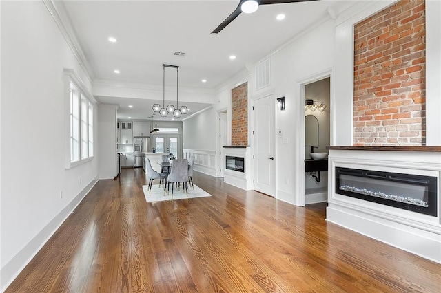 interior space with hardwood / wood-style flooring, crown molding, and ceiling fan