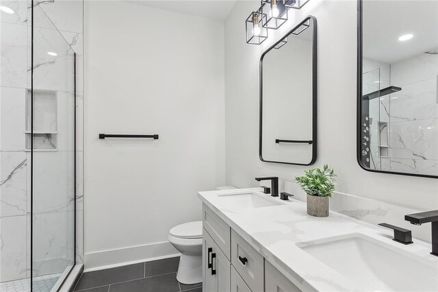 bathroom featuring toilet, tile patterned flooring, an enclosed shower, and vanity