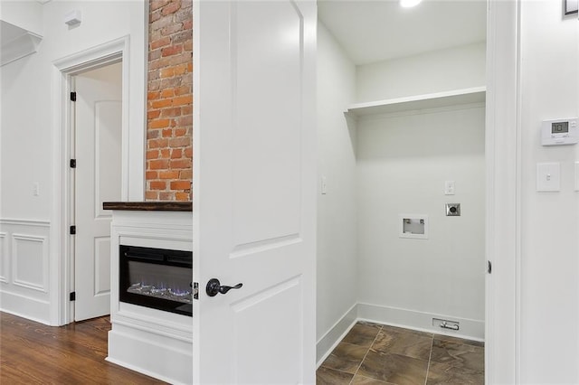 laundry area featuring washer hookup, hookup for an electric dryer, and a fireplace