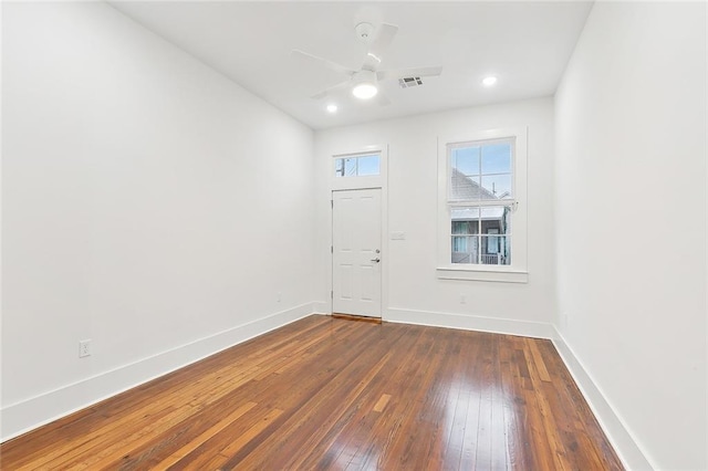 unfurnished room with dark hardwood / wood-style flooring and ceiling fan