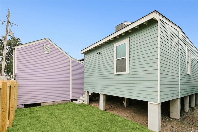 view of side of home featuring a yard