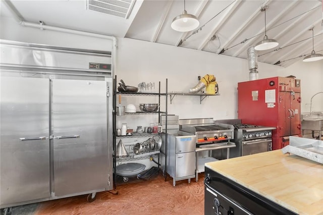 kitchen with hanging light fixtures and high end appliances