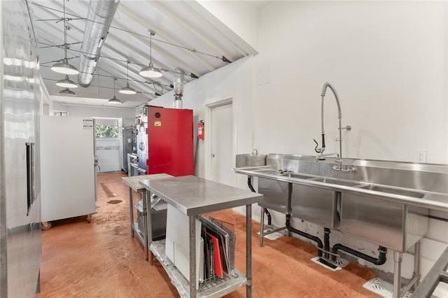 kitchen with white refrigerator and stainless steel counters