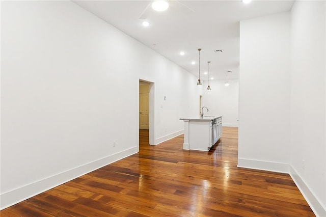 unfurnished living room featuring dark hardwood / wood-style flooring and sink