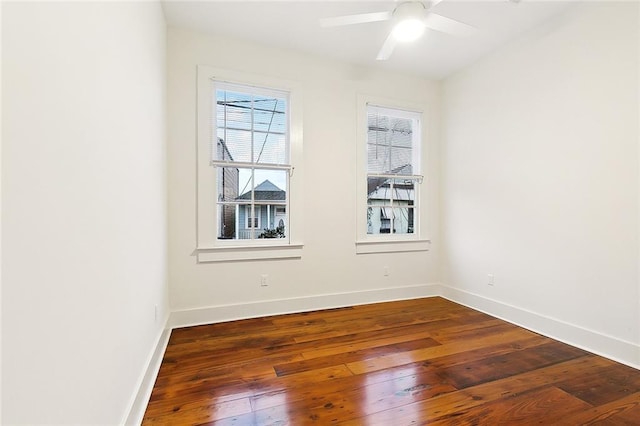 spare room with ceiling fan and dark wood-type flooring