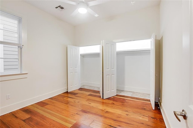 unfurnished bedroom with ceiling fan and light wood-type flooring