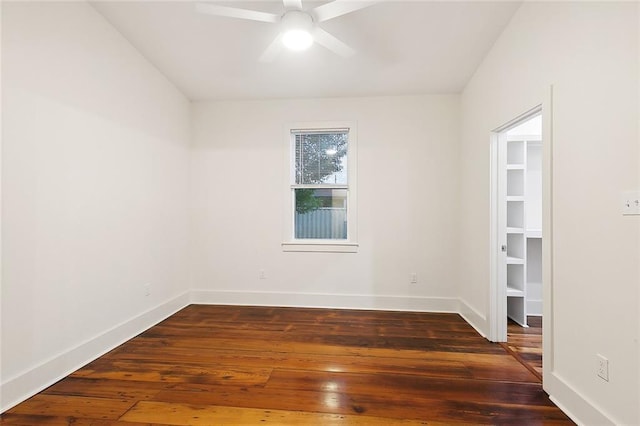 spare room featuring dark hardwood / wood-style flooring and ceiling fan