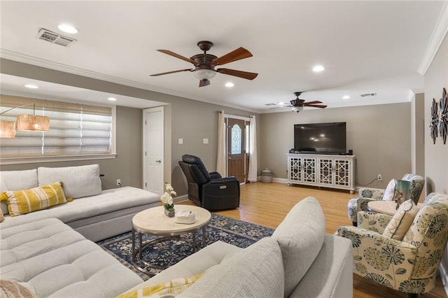 living room featuring light wood-type flooring, ceiling fan, and crown molding