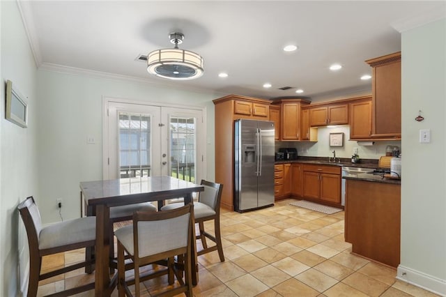 kitchen featuring french doors, sink, ornamental molding, light tile patterned flooring, and stainless steel fridge with ice dispenser