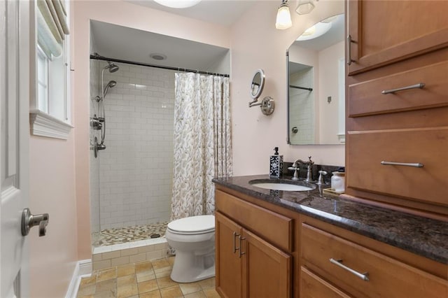 bathroom with vanity, toilet, and curtained shower