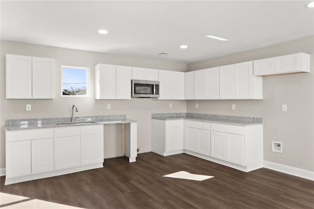 kitchen featuring white cabinetry, sink, and dark wood-type flooring